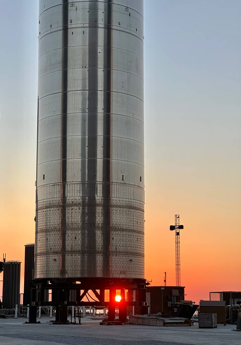 SpaceX Super Heavy booster on the pad at sunset